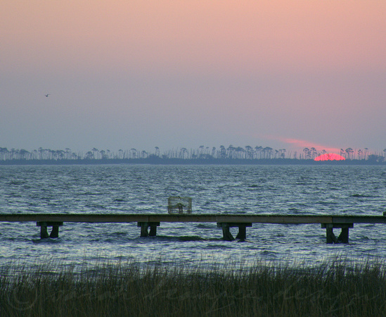 Bubblegum pink sun slips below Deer Island-East Beach
