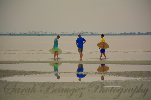 Three boys and their skim boards on East Beach