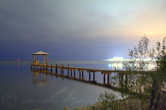 A simple pier lit by Biloxi lights