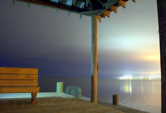 Pier and crab trap lit by Biloxi lights