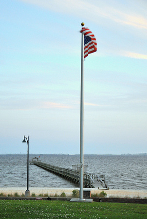 The American flag and the Gulf Oaks pier