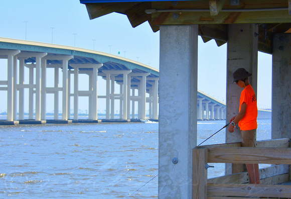 A boy and his fishing pole on the OS fishing bridge